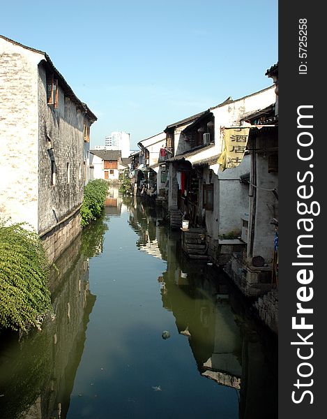 China, Zhejiang province, old town - Shaoxing with historical CanQiao street. Residential area is surrouded by water canals, which were water-roads for transportation in ancient times. Shaoxing is one of few watertowns in Zhejiang province. China, Zhejiang province, old town - Shaoxing with historical CanQiao street. Residential area is surrouded by water canals, which were water-roads for transportation in ancient times. Shaoxing is one of few watertowns in Zhejiang province.