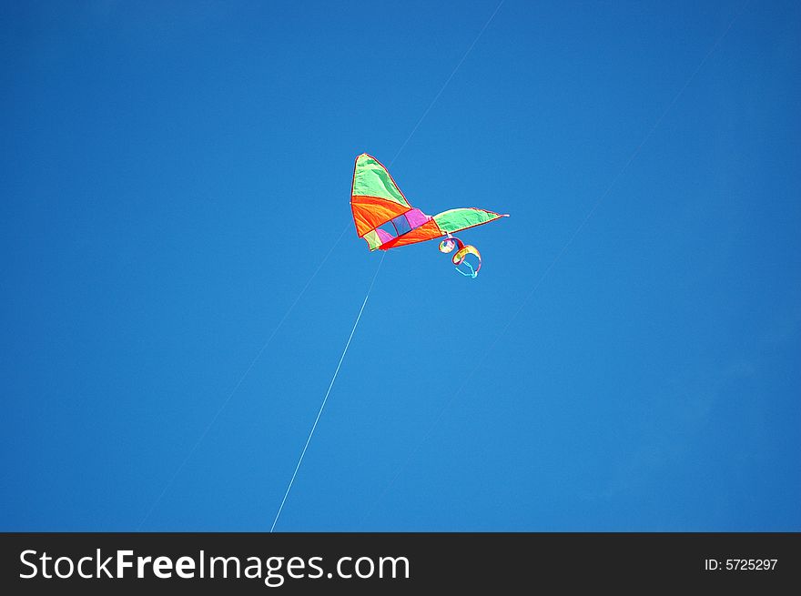 Chinese kite in park with blue sky as background. Chinese kite in park with blue sky as background.