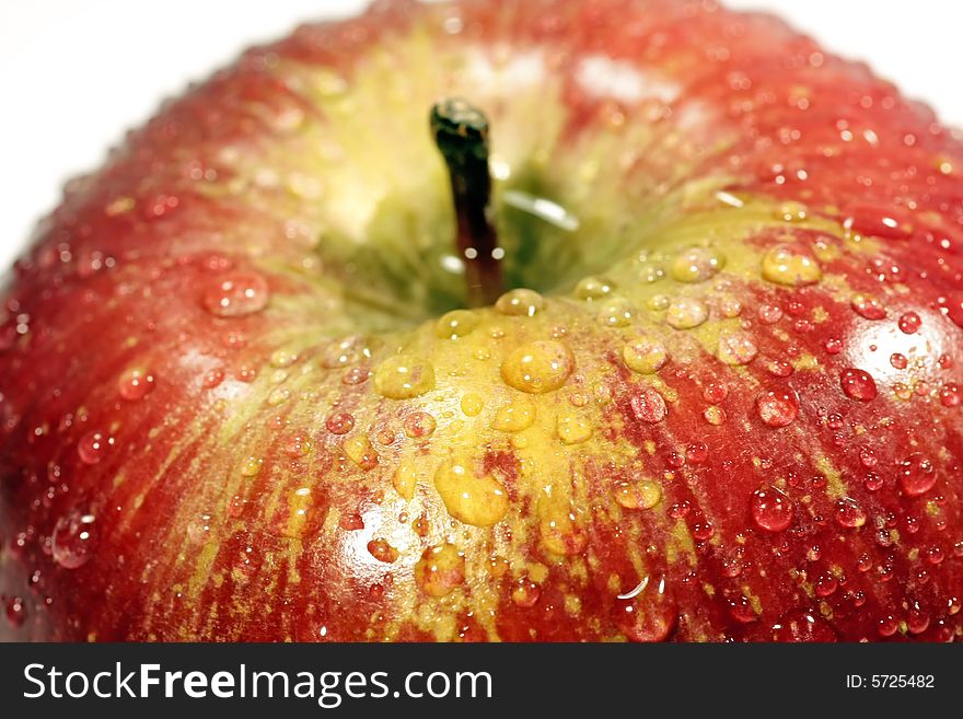 Bunch of drops of water on a red apple isolated on a white background. Bunch of drops of water on a red apple isolated on a white background.