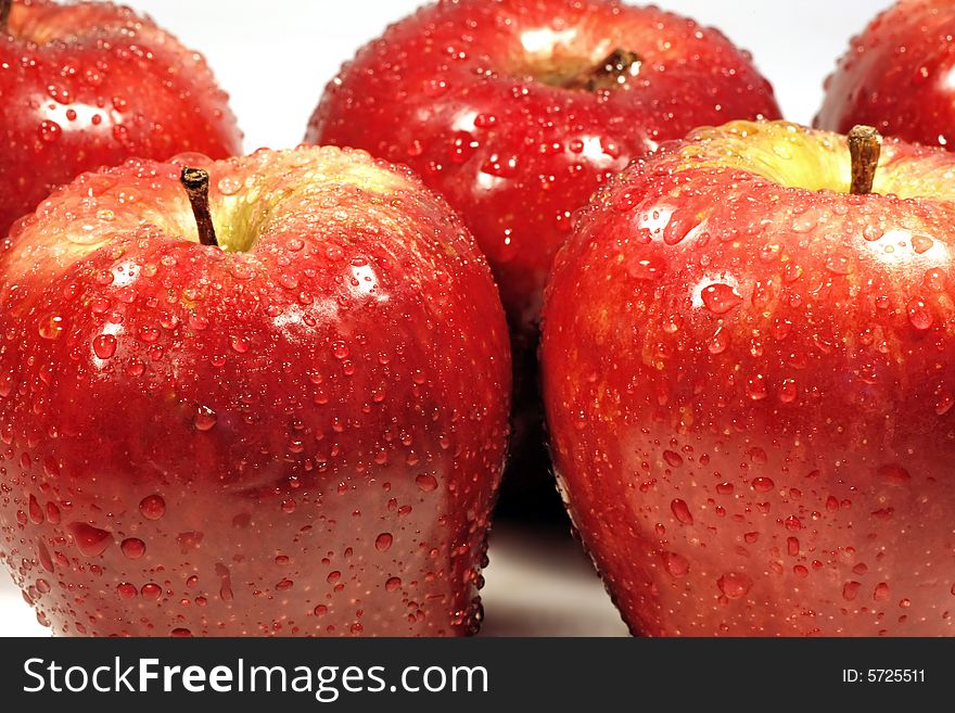 Bunch of red apples isolated on a white background, with drops of water.