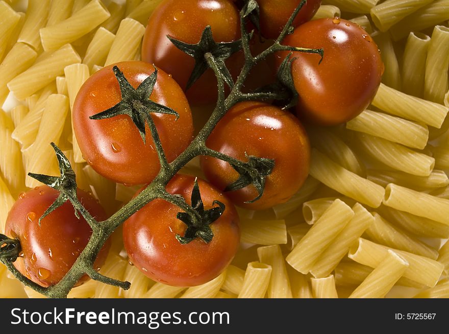 Red tomatoes with water drops and pasta. Red tomatoes with water drops and pasta