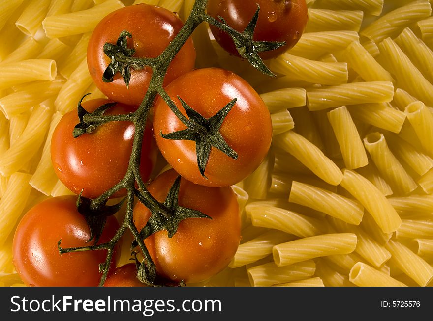 Red tomatoes with water drops and pasta. Red tomatoes with water drops and pasta