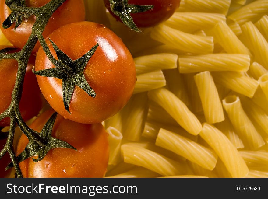 Red tomatoes with water drops and pasta. Red tomatoes with water drops and pasta