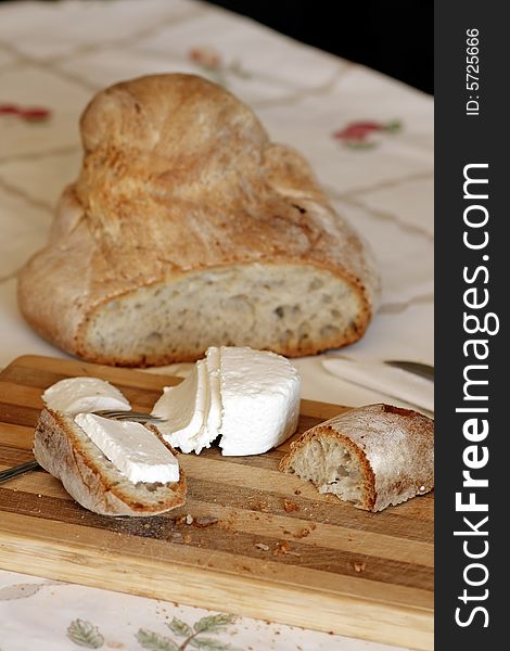 Traditional and portuguese fresh cheese and bread sliced on a table.