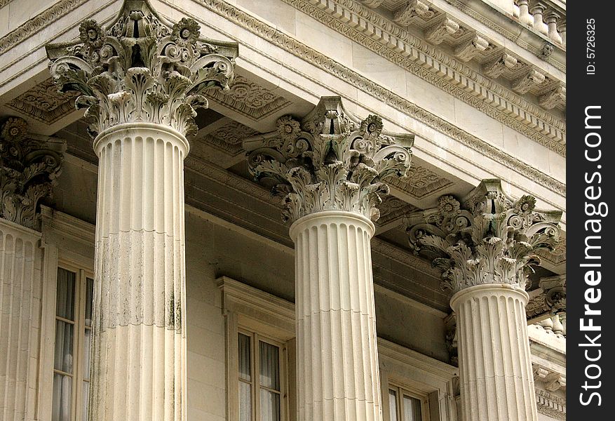 Three stone concrete columns with ornate pedestals. Three stone concrete columns with ornate pedestals