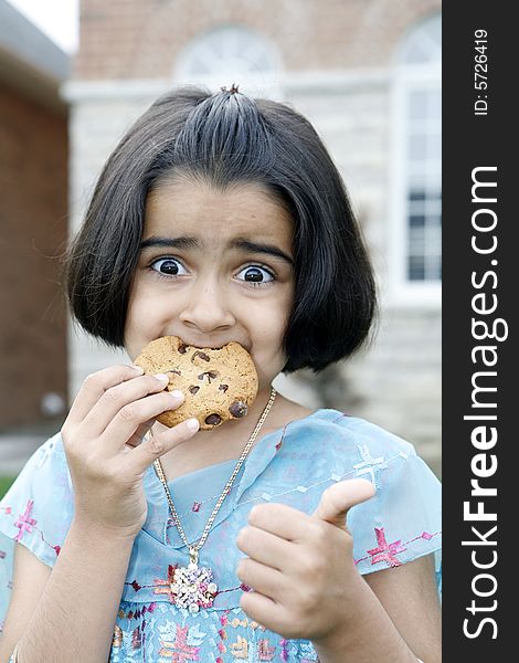 Little Girl Enjoying Cookie