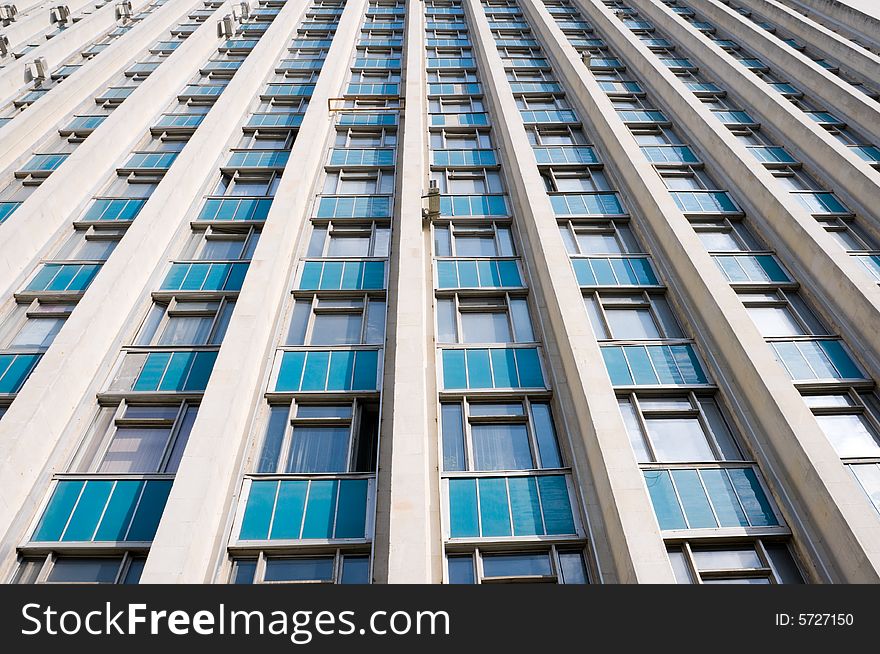Tall office building exterior, perspective pattern with windows, wide angle shot