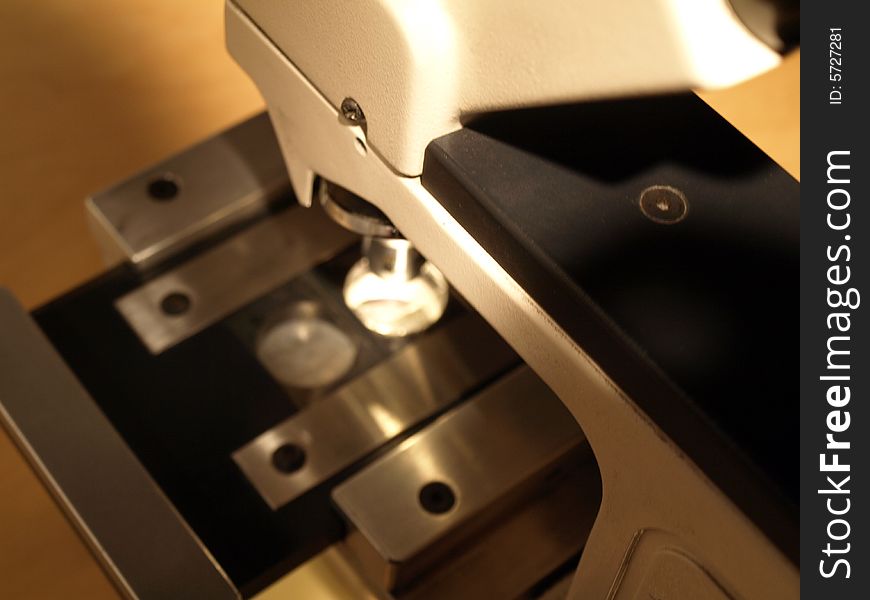 Looking down at a professional scientific microscope.