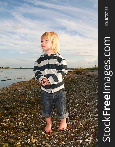 Child on beach looking out over the sea. Child on beach looking out over the sea