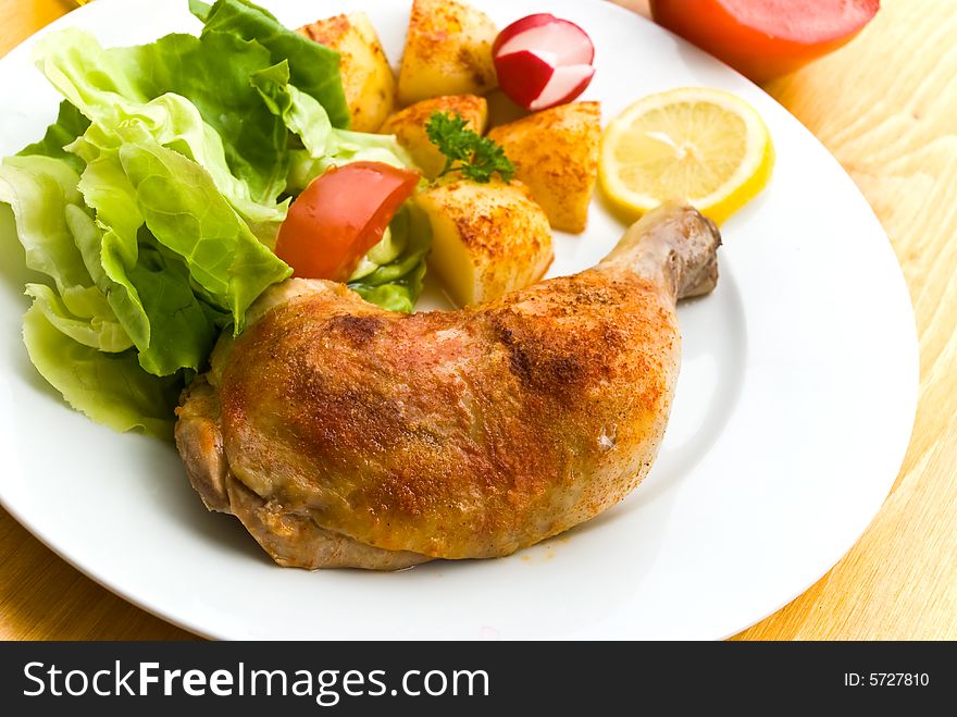 Fried chicken with fried potatoes,lettuce and tomato,radish