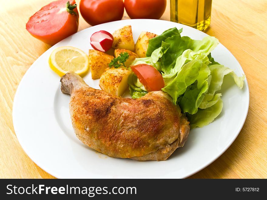 Fried chicken with fried potatoes,lettuce and tomato,radish