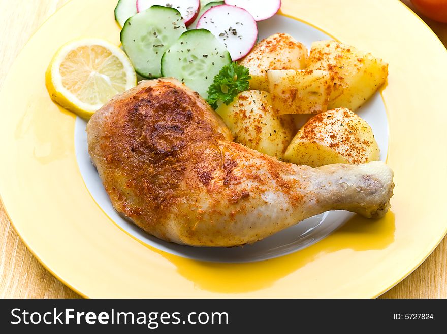 Fried chicken with fried potatoes, and cucumber,to