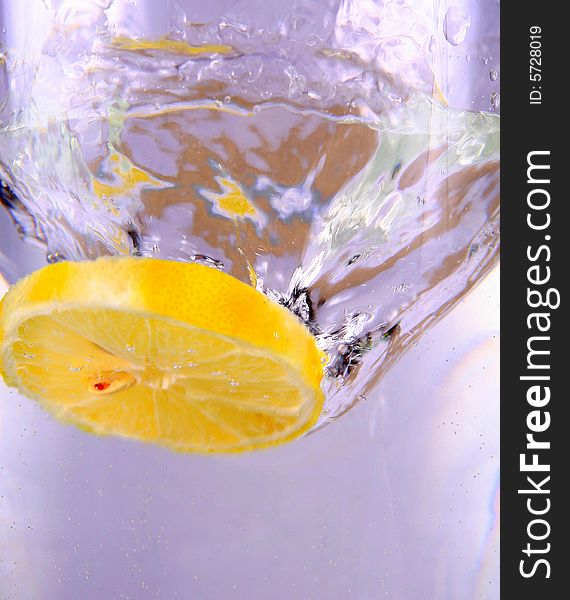 Lemon falls into water. A conceptual shot of freshness. Lemon falls into water. A conceptual shot of freshness.