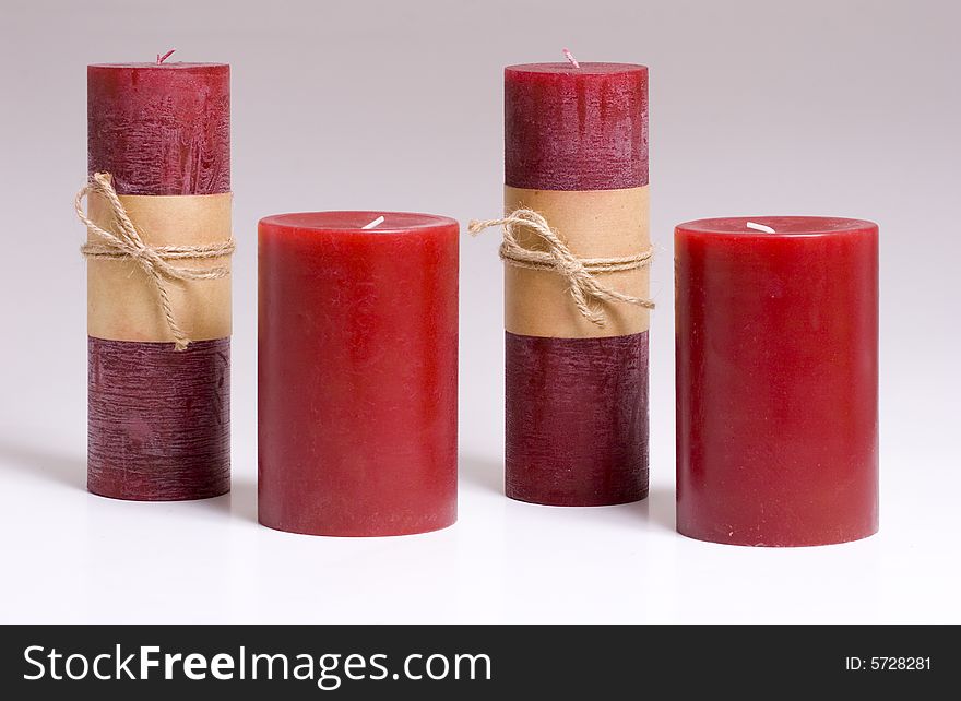 Four red candles on a grey background