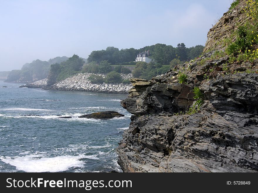 Waves crashing on a rocky shore and cliff. Waves crashing on a rocky shore and cliff