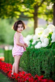 Girl In Flower Garden Royalty Free Stock Photo