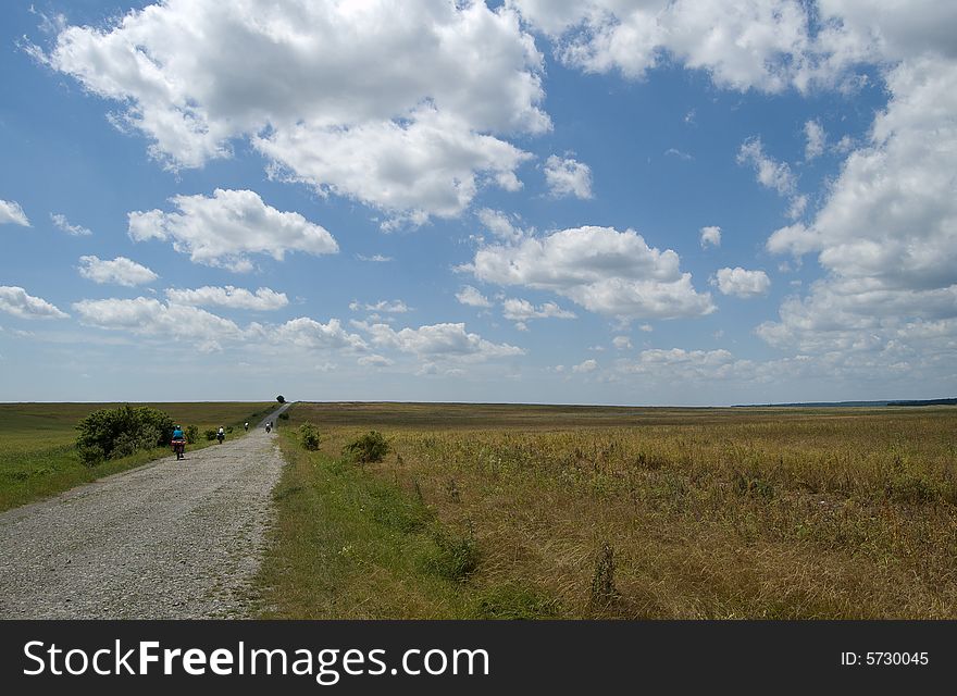 Rural landscape with bikers on the road