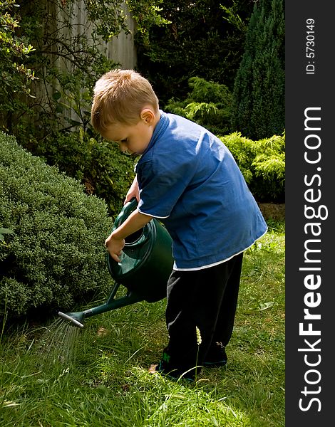 Little boy watering the garden. Little boy watering the garden