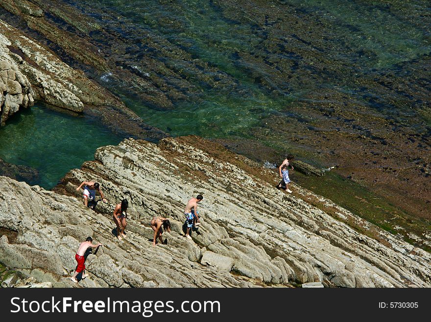 An image of young people walking on the rocks. An image of young people walking on the rocks.