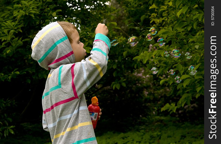 Little boy jplaying with the bubbles