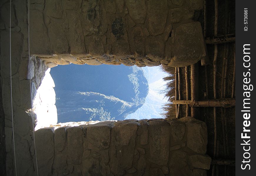 View through the window of a stone building at Machu Picchu. View through the window of a stone building at Machu Picchu.