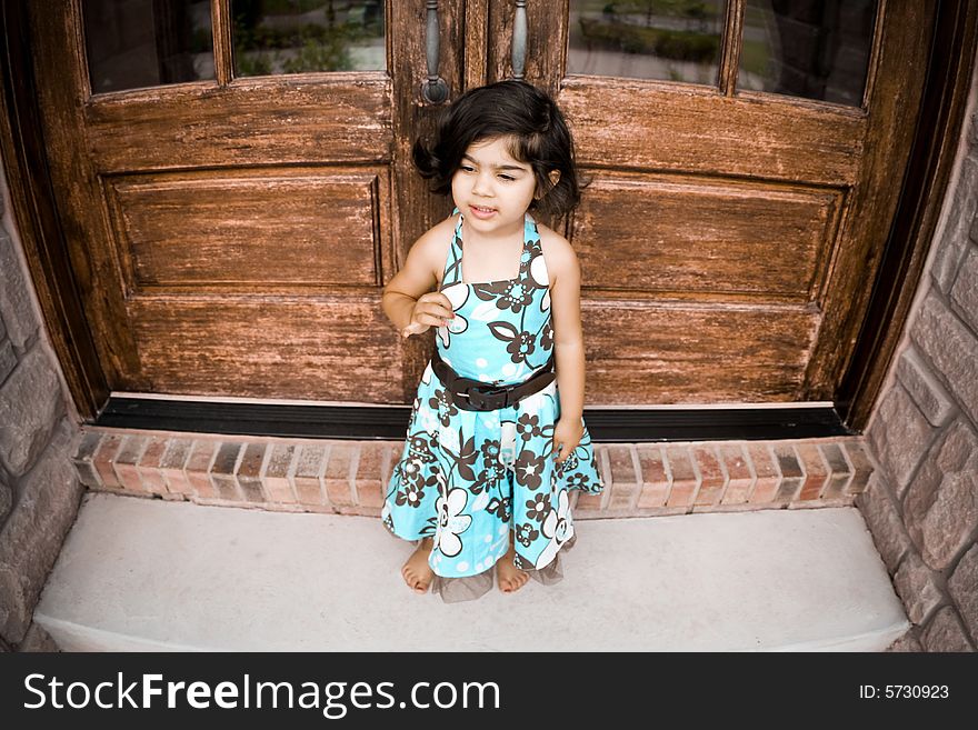 Child sitting by an antique door. Child sitting by an antique door