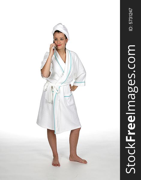 Teenage girl in towel and robe talking on cell phone. Teenage girl in towel and robe talking on cell phone