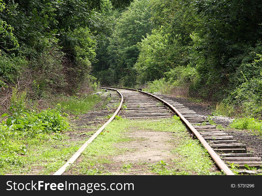 Old abandoned railroad tracks curving into the horizon