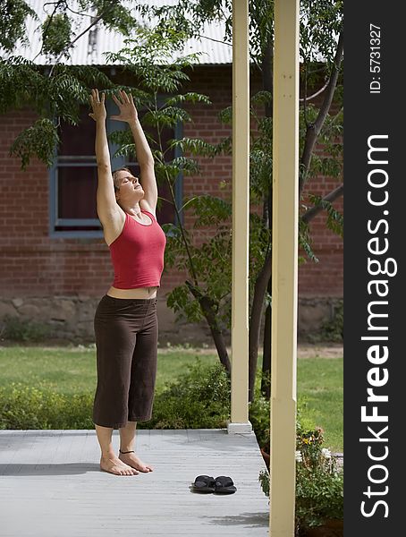 Pretty Young Woman doing Yoga on a Porch. Pretty Young Woman doing Yoga on a Porch