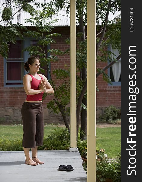 Pretty Young Woman doing Yoga on a Porch. Pretty Young Woman doing Yoga on a Porch