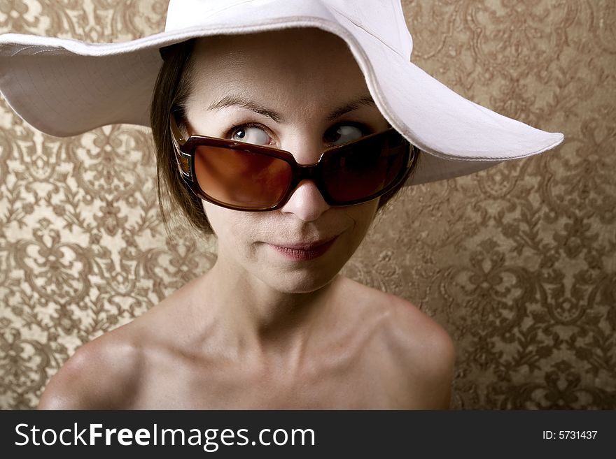 Young Woman with Sunglasses and a Floppy White Hat