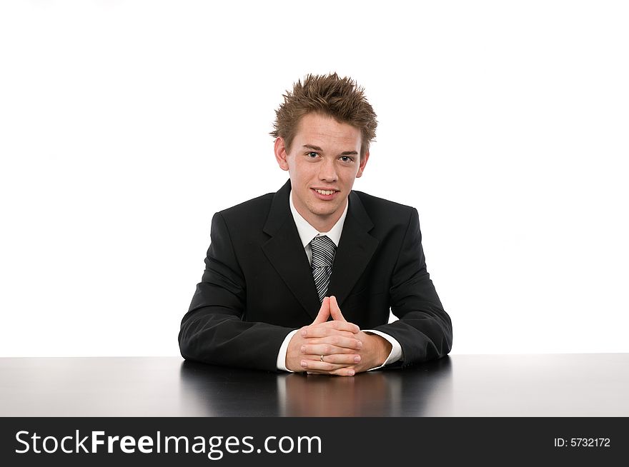 A young businessman sitting in his office