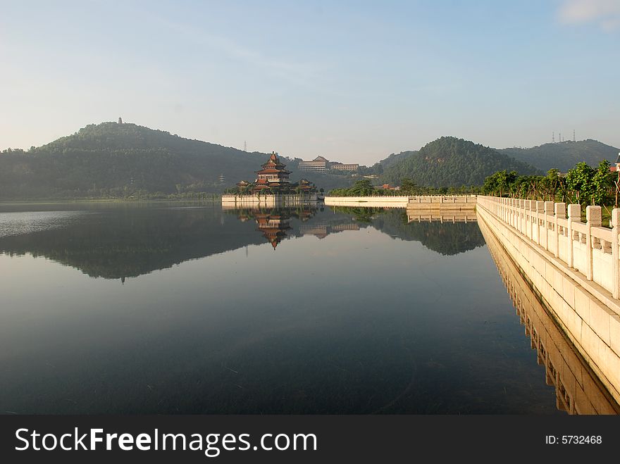 The Chinese imperial garden with big lake,long stone marble railings and storeyed pavilion on the terrace in lake. The Chinese imperial garden with big lake,long stone marble railings and storeyed pavilion on the terrace in lake.