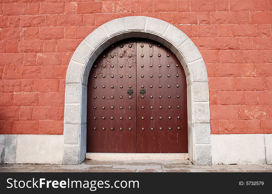 The Chinese ancient red wall and  wood door of an imperial palace. The Chinese ancient red wall and  wood door of an imperial palace.