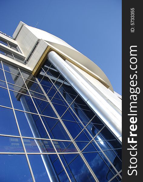 High modern building with mirror glasses and sky reflections. High modern building with mirror glasses and sky reflections
