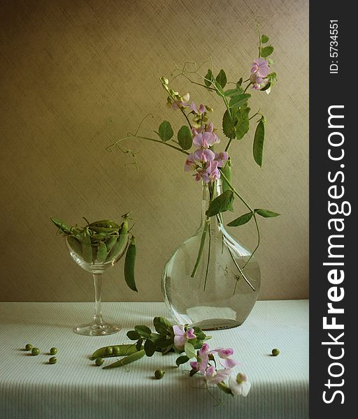 Still life with peas and glass