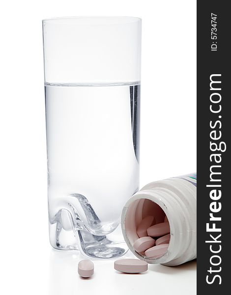 Glass with water and pills in container, isolated, with clipping path, over white