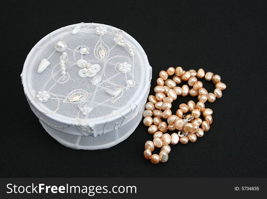 White embroidered jewelery box with a string of pearls