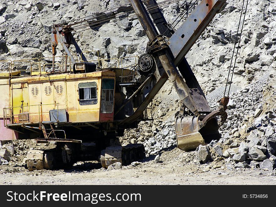 A power-shovel works in a career