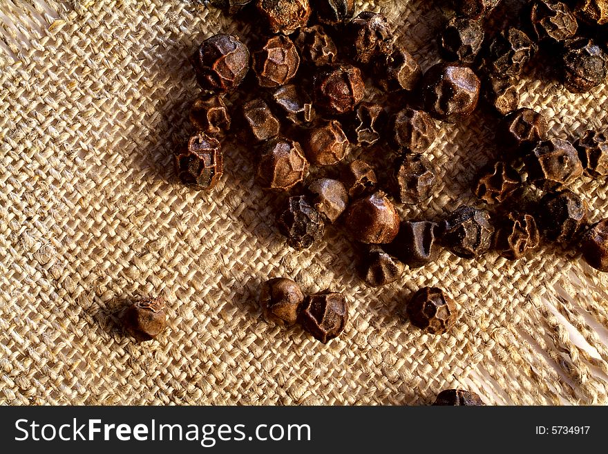 Grains of black pepper on a sacking