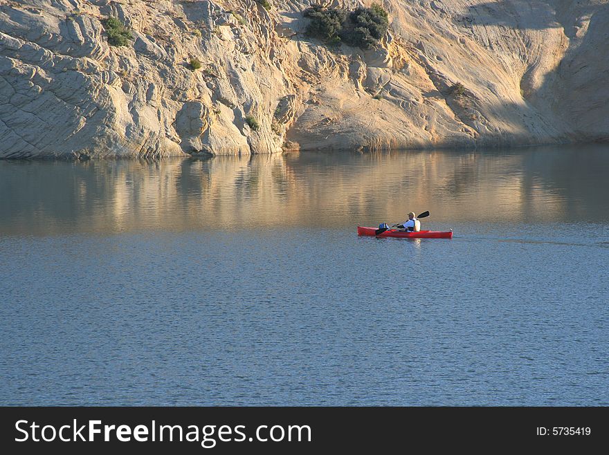 A solo kayaker on a lake