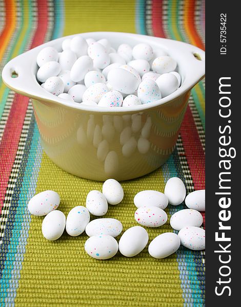 Miniature speckled easter eggs in a green bowl