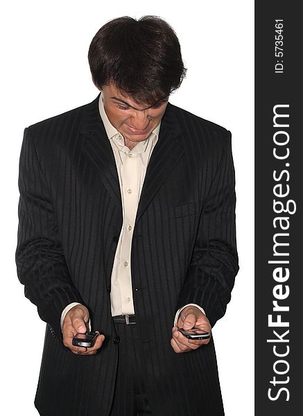 Angry businessman holding two mobile phones, isolated on white background