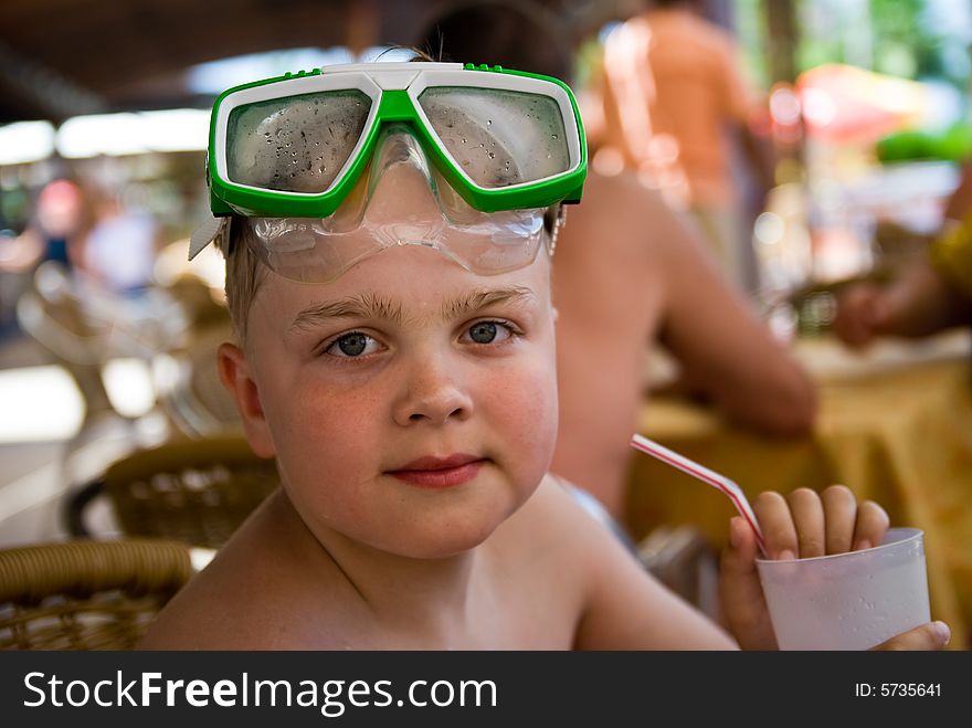 Boy on vacations with mask and cocktail