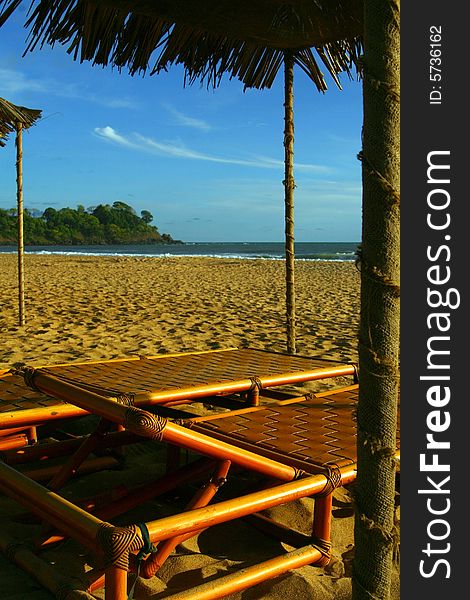 Beautiful beach with little huts and wooden benches. Ideal vacation / summer shot. Beautiful beach with little huts and wooden benches. Ideal vacation / summer shot.
