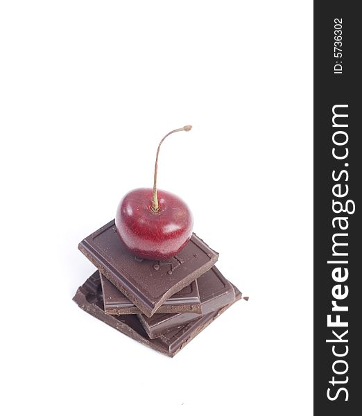 Sweet chocolate with red cherry isolated at white background. Sweet chocolate with red cherry isolated at white background