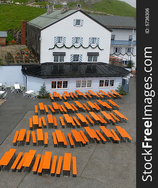 Terrace of high-mountain Alps restaurant with orange tabels
