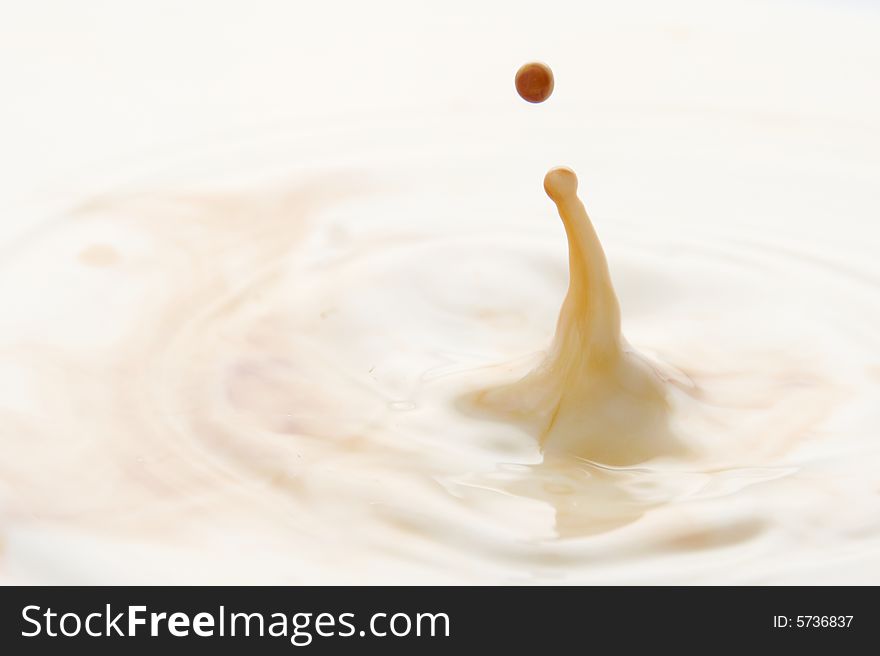 Macro shot of coffee dripping into milk. Macro shot of coffee dripping into milk