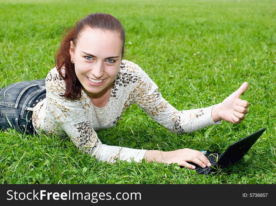 Smiling student with notebook on the grass. Smiling student with notebook on the grass