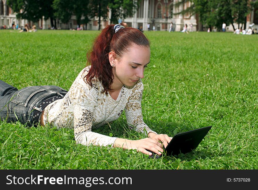 Student with notebook on the grass. Student with notebook on the grass